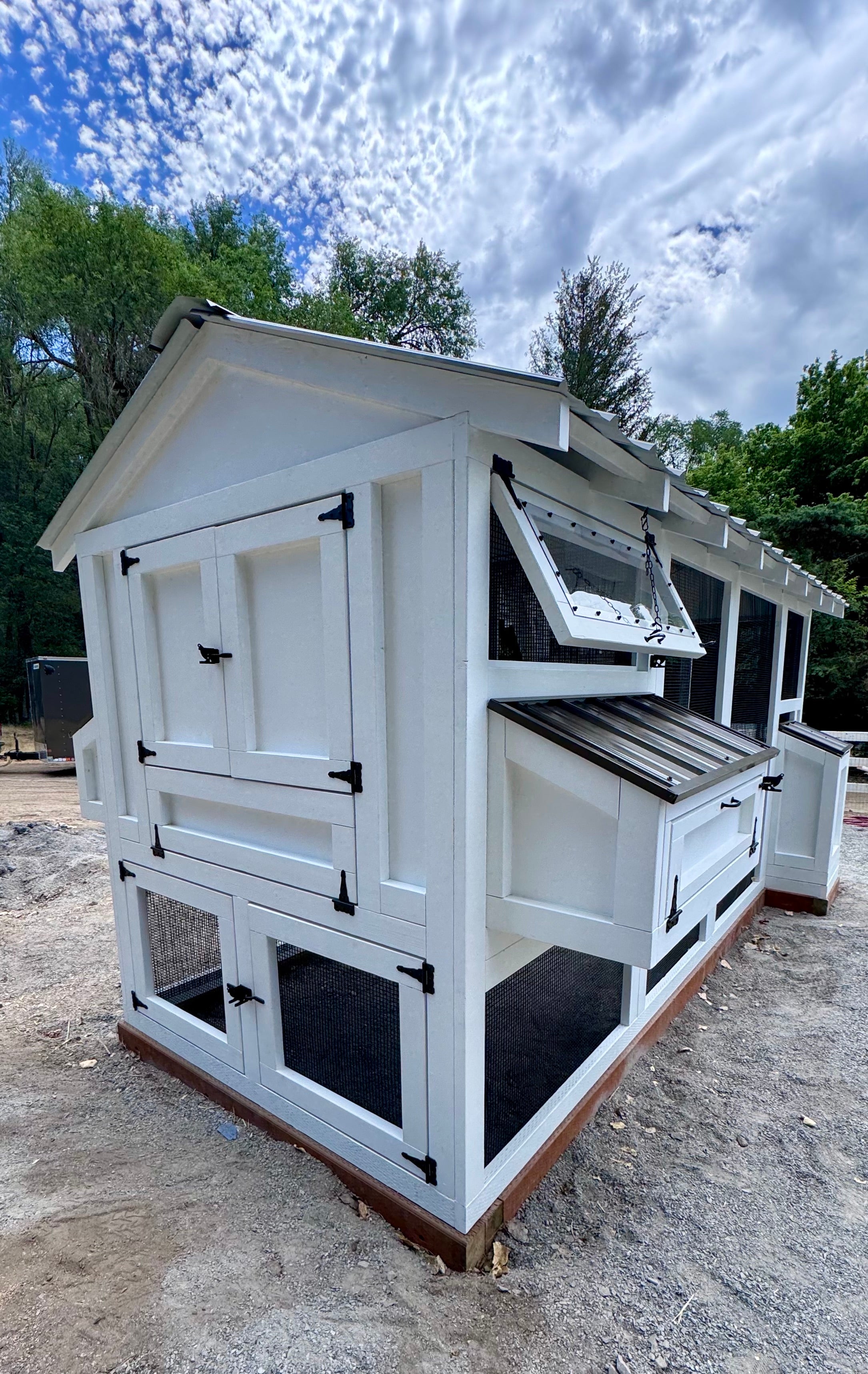 A premium, handcrafted chicken coop set on a profitable ranch property with a small farm operation, designed with modern features to promote healthy backyard chicken keeping and living.