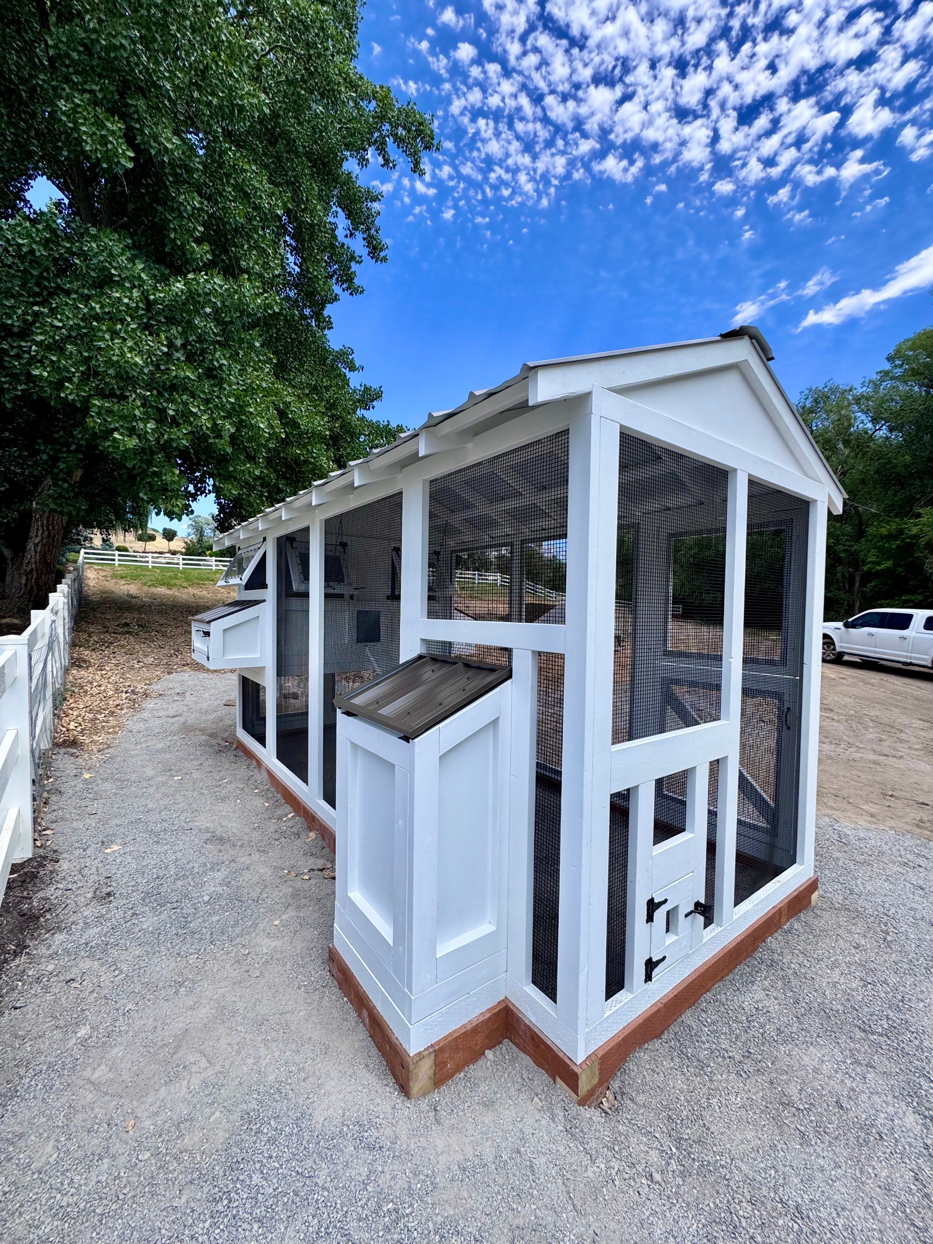 Luxury custom chicken coop on a spacious estate, designed to accommodate a large flock, offering premium living for chickens in an upscale property.